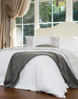 White damask duvet cover bedding set with gray throw in elegant bedroom