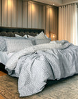 Bedroom with a bed featuring patterned bedding and pillows.