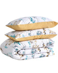 Provance floral duvet cover set with yellow and blue botanical print, stacked with pillowcases