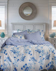 Blue floral duvet cover set on a bed in a bright bedroom with coastal decor