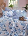Sevilla blue floral duvet cover set on a bed with matching pillows in a pastel bedroom
