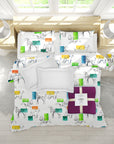 Colorful bedding set with animal pattern on a bed in a bright room.