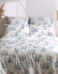 Blue and white toile de Jouy duvet cover set on bed in bright modern bedroom