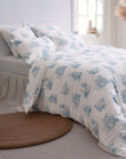 Blue and white toile de Jouy duvet cover set on a bed in a bright, modern bedroom