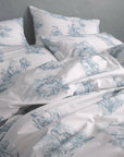 Blue and white toile de Jouy duvet cover set with vintage scenic pattern on bed