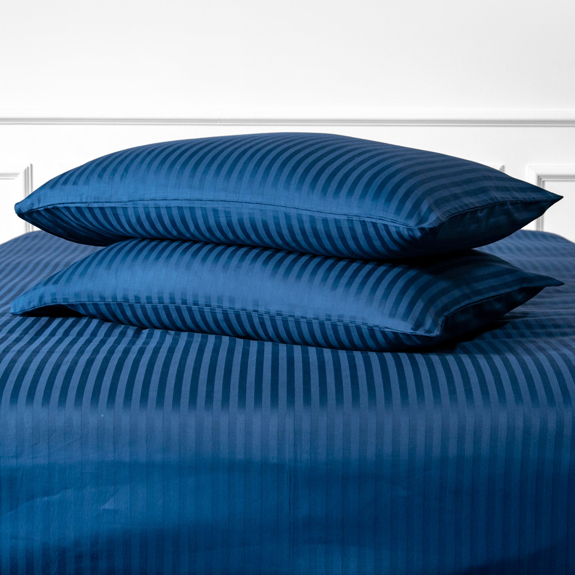 Une paire de taies d'oreiller standard en satin de coton 100 % rayé bleu marine