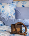 Sevilla blue floral duvet cover set with striped pillows and rustic wooden decor box