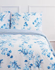 Sevilla blue floral duvet cover set with matching pillowcases on a modern bed