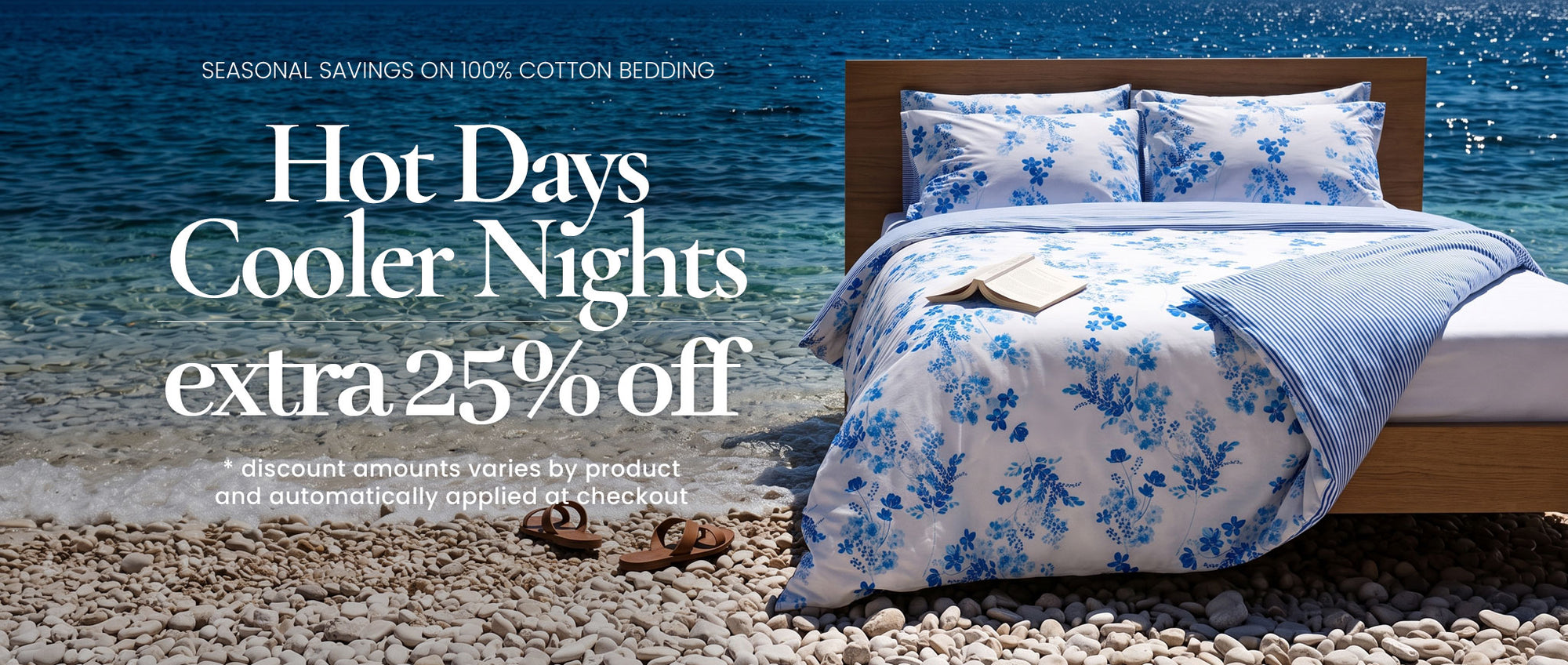 A bed dressed in a blue and white floral-patterned cotton bedding set, styled on a pebble beach with ocean water in the background. Large promotional text on the left reads 'Hot Days Cooler Nights extra 25% off'.