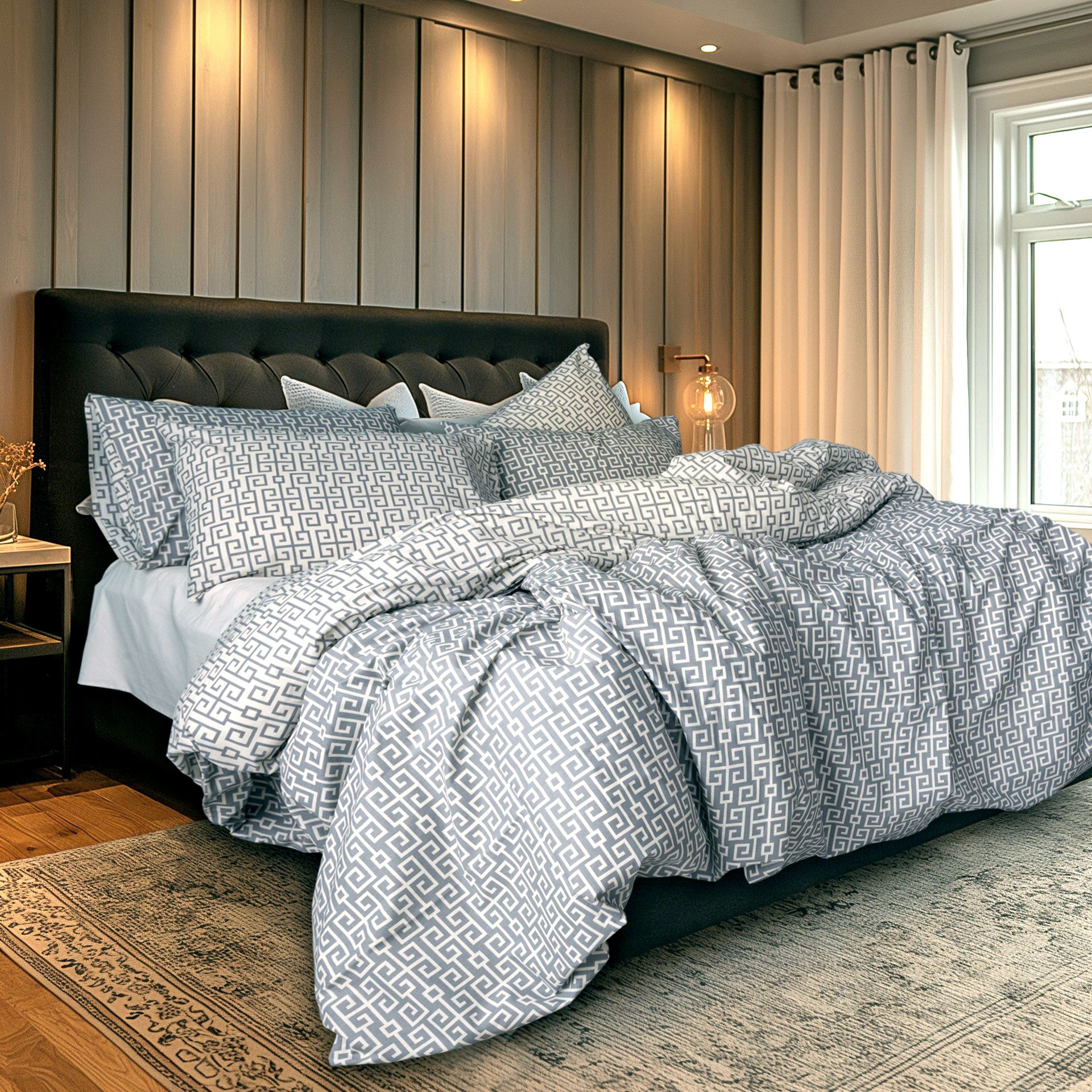 Bedroom with a bed featuring patterned bedding and pillows.