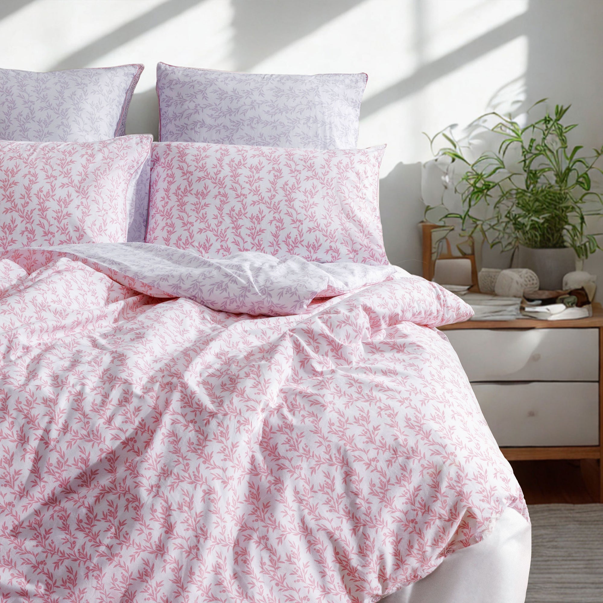 Floral bedding set on a bed with a blurred background
