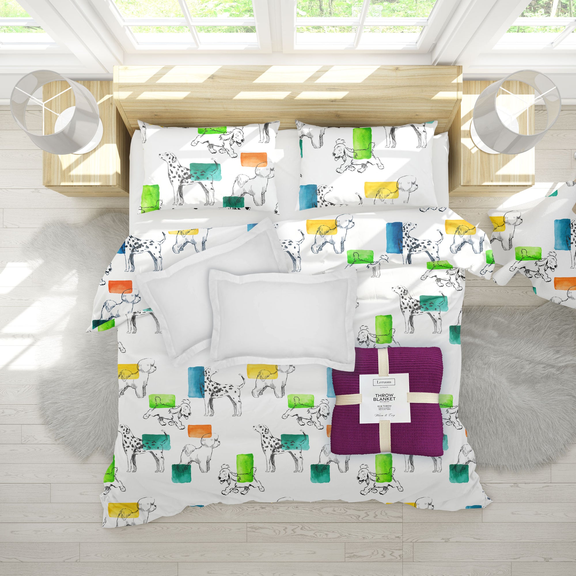 Colorful bedding set with animal pattern on a bed in a bright room.